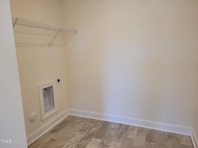 clothes washing area featuring electric dryer hookup and baseboards