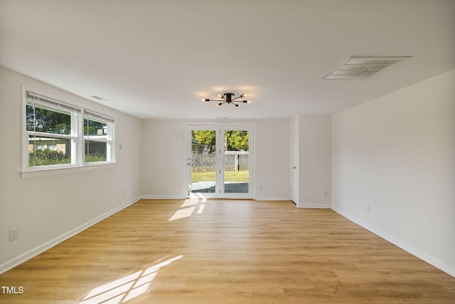 spare room with light hardwood / wood-style floors