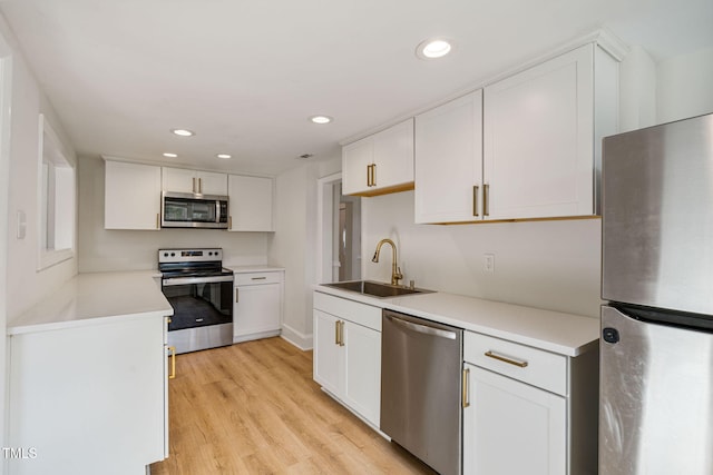 kitchen featuring white cabinetry, appliances with stainless steel finishes, and light hardwood / wood-style flooring