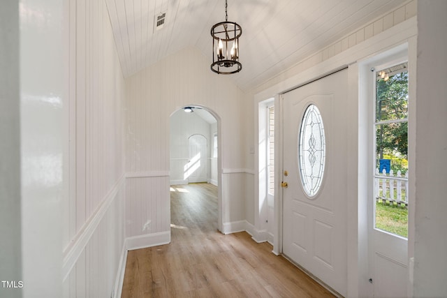 entryway with a chandelier, vaulted ceiling, light hardwood / wood-style floors, and wooden ceiling