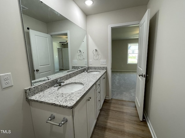 108 Pate Landing Dr, Selma, NC 27576 - bathroom with double vanity, baseboards, a sink, and wood finished floors
