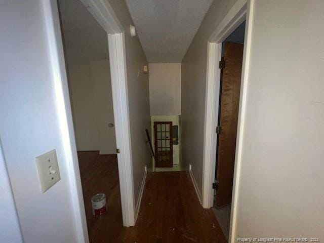 hall with dark wood-type flooring