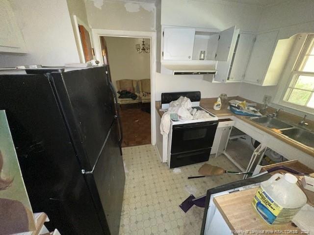 kitchen with white cabinetry, black appliances, sink, and ventilation hood