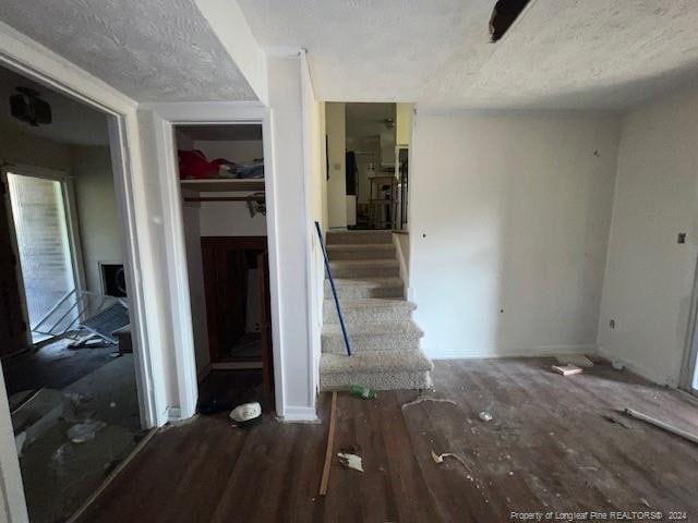 interior space featuring a textured ceiling and hardwood / wood-style floors