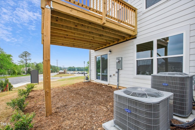 view of yard featuring central AC and a deck