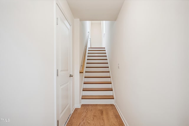 stairway featuring wood-type flooring