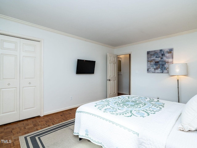 bedroom featuring a closet, ornamental molding, and dark parquet flooring