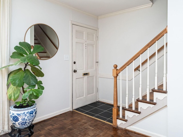 entrance foyer with crown molding, stairs, and baseboards