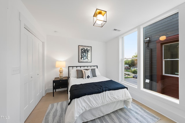 bedroom with a closet and light hardwood / wood-style flooring