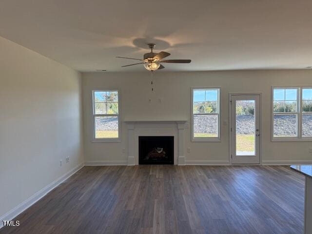 unfurnished living room with ceiling fan and dark hardwood / wood-style floors