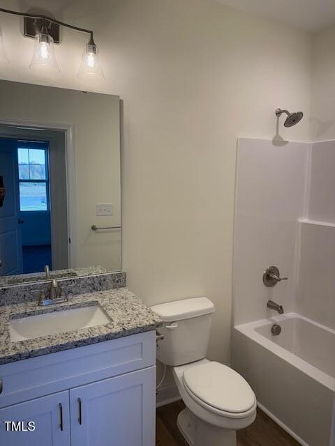 full bathroom featuring toilet, vanity, and shower / bathing tub combination