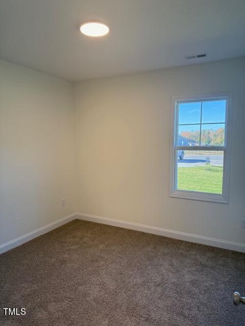 empty room with dark carpet