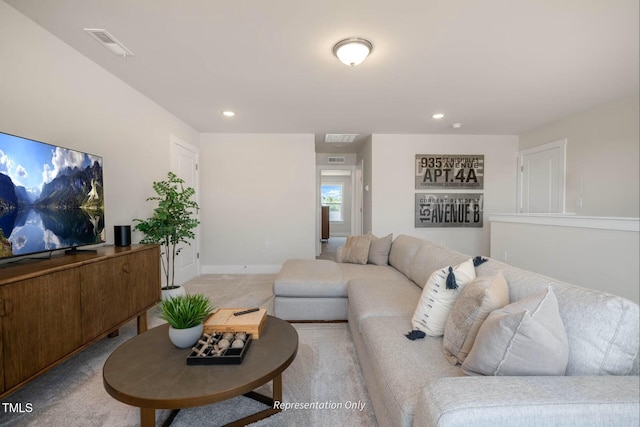 living area featuring recessed lighting and visible vents