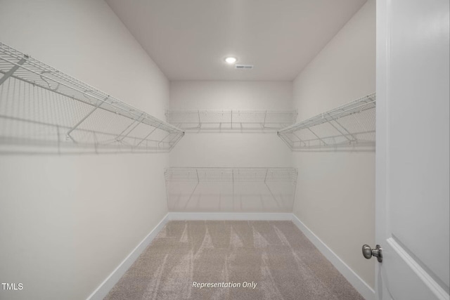 walk in closet with visible vents and carpet floors