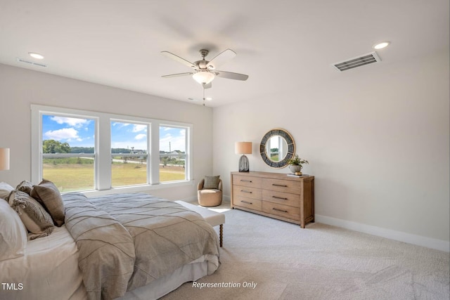 bedroom with baseboards, light colored carpet, recessed lighting, and visible vents