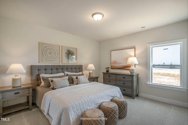 bedroom featuring light colored carpet, baseboards, and visible vents