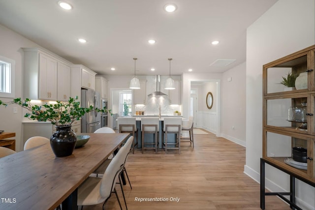 dining area with recessed lighting, baseboards, visible vents, and light wood-type flooring