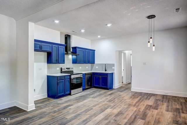 kitchen featuring dark wood-type flooring, blue cabinetry, stainless steel appliances, and wall chimney range hood