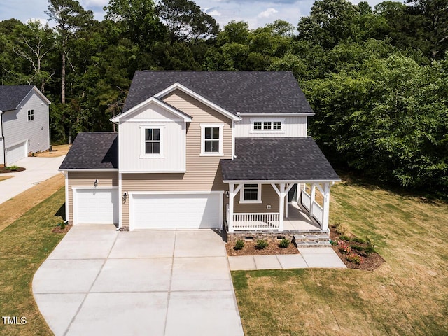view of front of house with covered porch, driveway, a front lawn, an attached garage, and board and batten siding