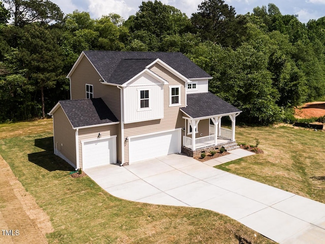 view of front of property featuring a porch, driveway, an attached garage, a front lawn, and board and batten siding