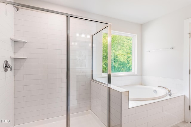 full bathroom featuring a stall shower and a bath