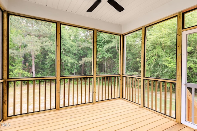 unfurnished sunroom with a ceiling fan