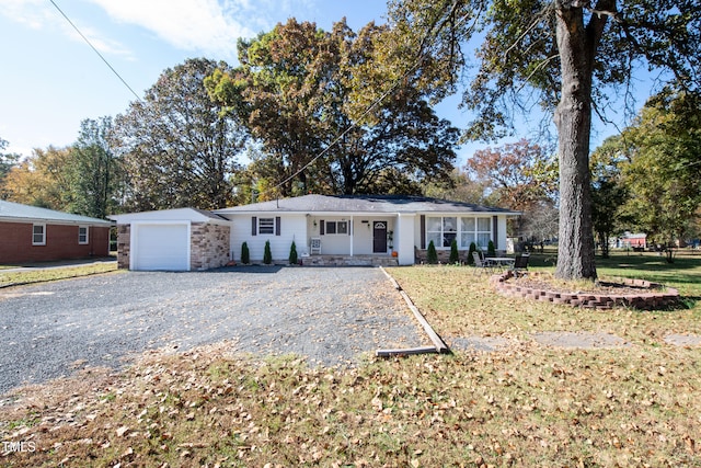 ranch-style home with covered porch and a front lawn