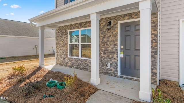 doorway to property featuring a porch