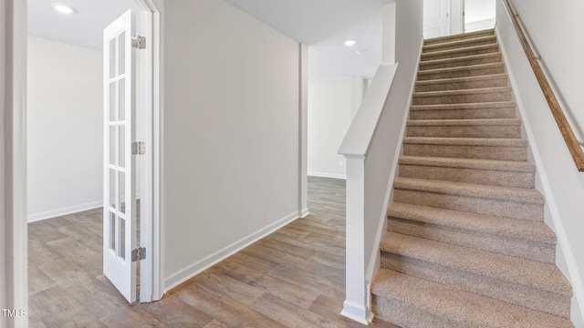 staircase featuring hardwood / wood-style floors