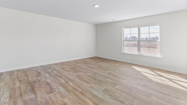 spare room featuring light wood-type flooring