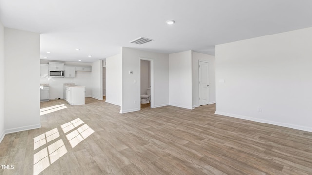 unfurnished living room with light hardwood / wood-style floors