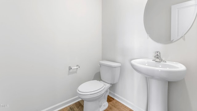 bathroom with sink, hardwood / wood-style flooring, and toilet