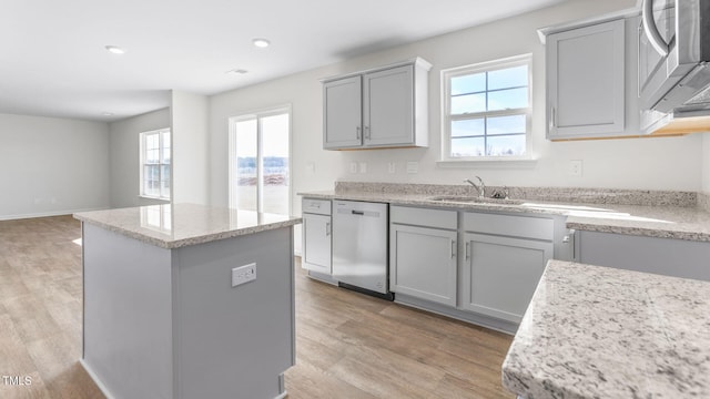 kitchen featuring a kitchen island, gray cabinetry, stainless steel appliances, and light hardwood / wood-style floors