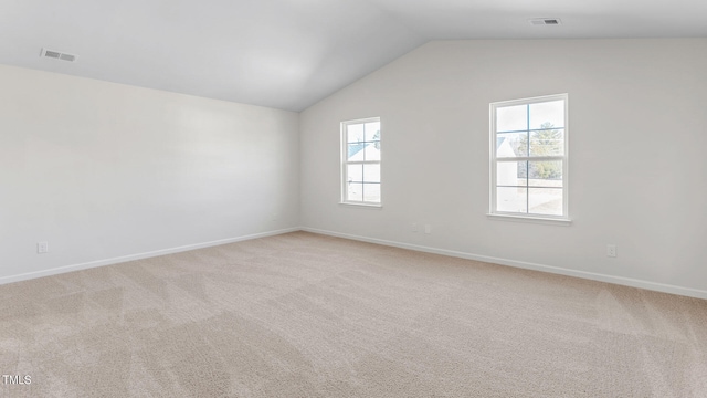 unfurnished room featuring carpet and vaulted ceiling