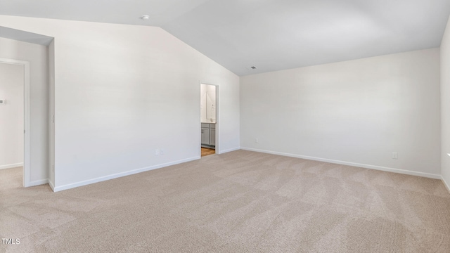 empty room with light carpet and lofted ceiling