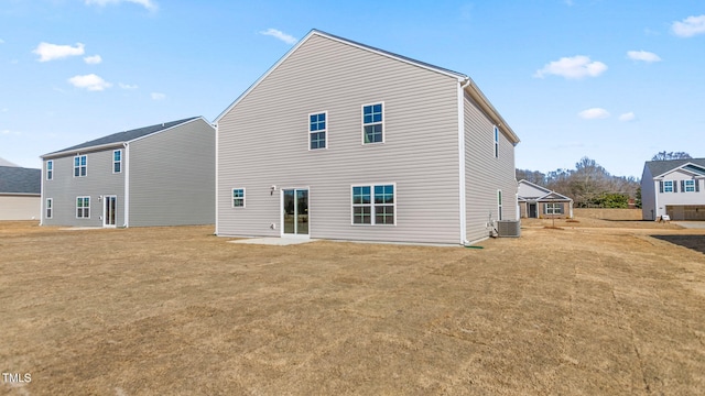 rear view of property with a yard and central AC unit