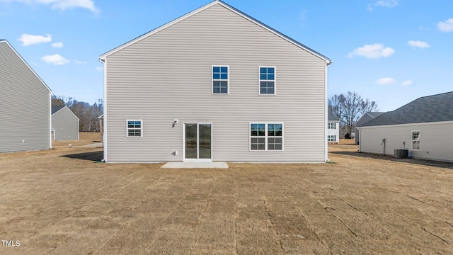 back of property with a patio, central AC unit, and a lawn