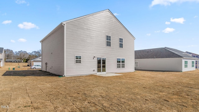 rear view of house featuring a yard and a patio area