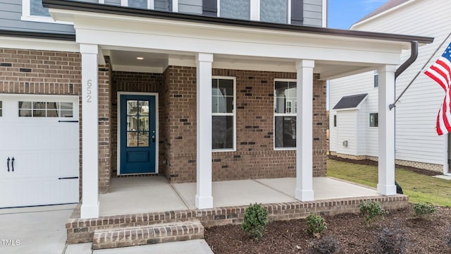 entrance to property with a garage and covered porch