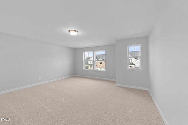 unfurnished room featuring light colored carpet