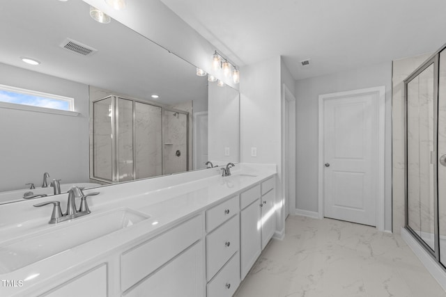 bathroom featuring vanity and an enclosed shower