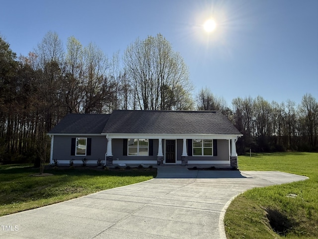 single story home with driveway and a front yard