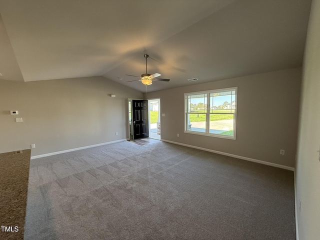 interior space with a ceiling fan, baseboards, vaulted ceiling, and visible vents