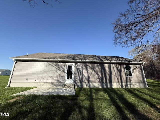 view of property exterior featuring a yard and a patio