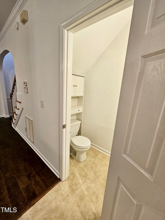 bathroom featuring hardwood / wood-style flooring and toilet