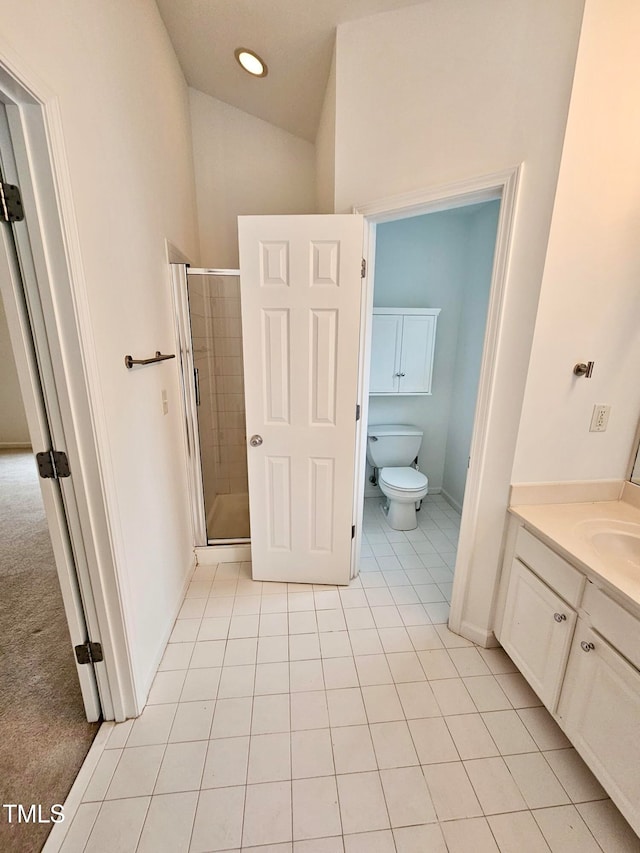 bathroom featuring tile patterned floors, vanity, toilet, and walk in shower