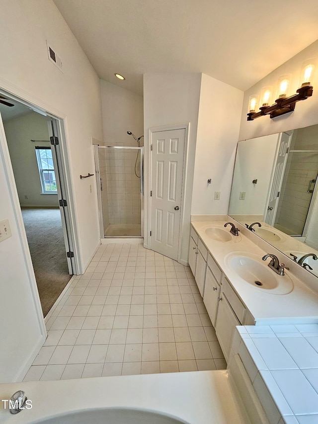 bathroom featuring tile patterned floors, vanity, and walk in shower