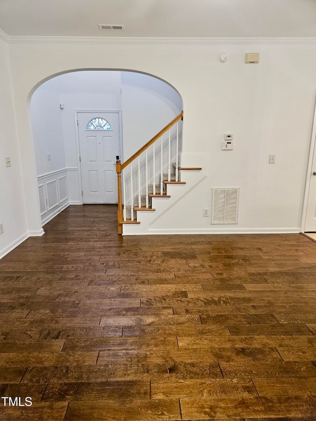 entrance foyer featuring dark hardwood / wood-style flooring and ornamental molding