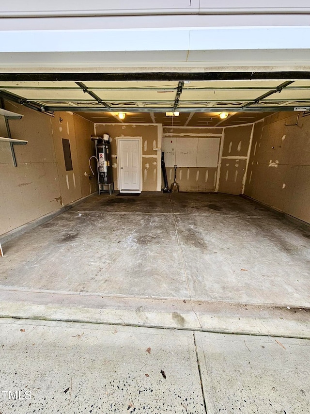 garage featuring electric panel, a garage door opener, and gas water heater