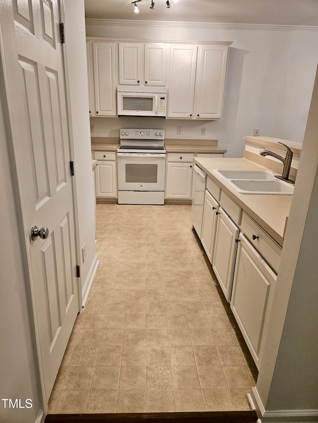 kitchen featuring white appliances, sink, light tile patterned floors, and ornamental molding